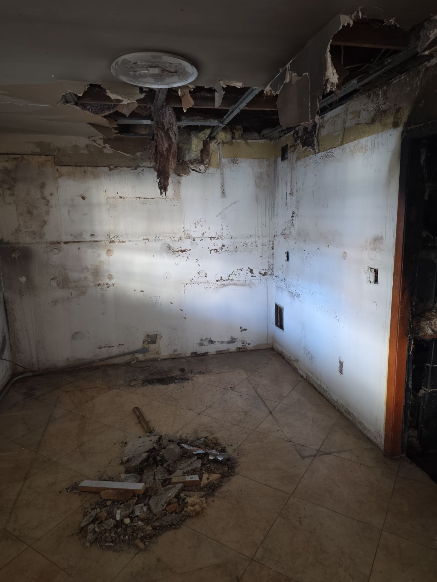 Room stripped to bare walls and ceiling after fire remediation